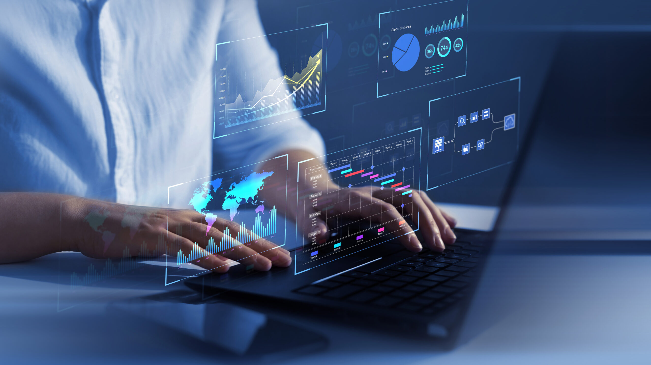 Person working on a laptop with icons floating above the keyboard.
