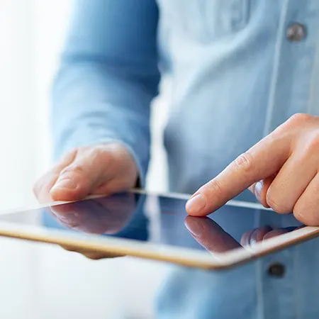 Person holding a tablet.
