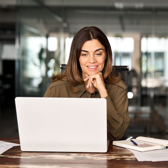 Woman working on a laptop.